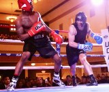 Naval Air Station Lemoore's Erick Blue (left) fights Air Force fighter Norberto Cano Saturday night (April 6) in the "Battle of the Badges" held in Hanford's Civic Auditorium.